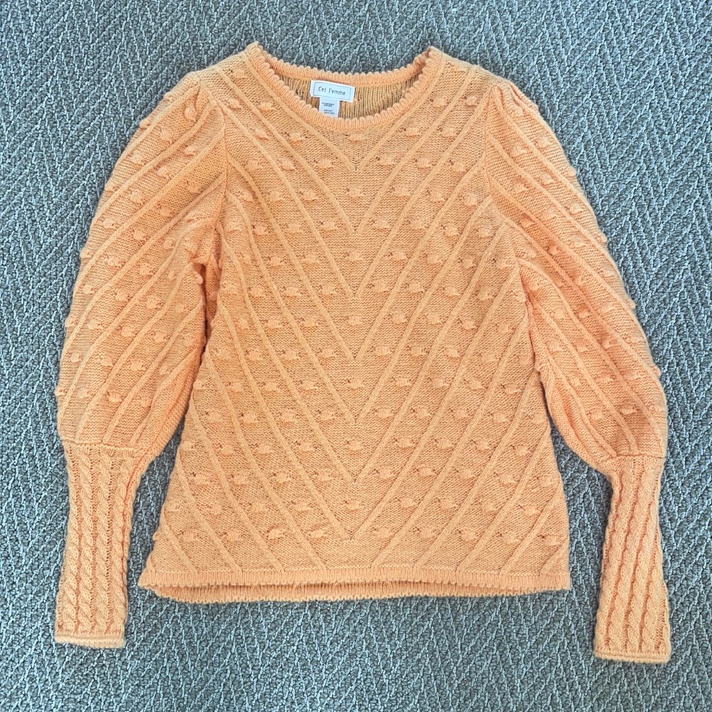 Ces Femme light orange sweater with polka dot detail.